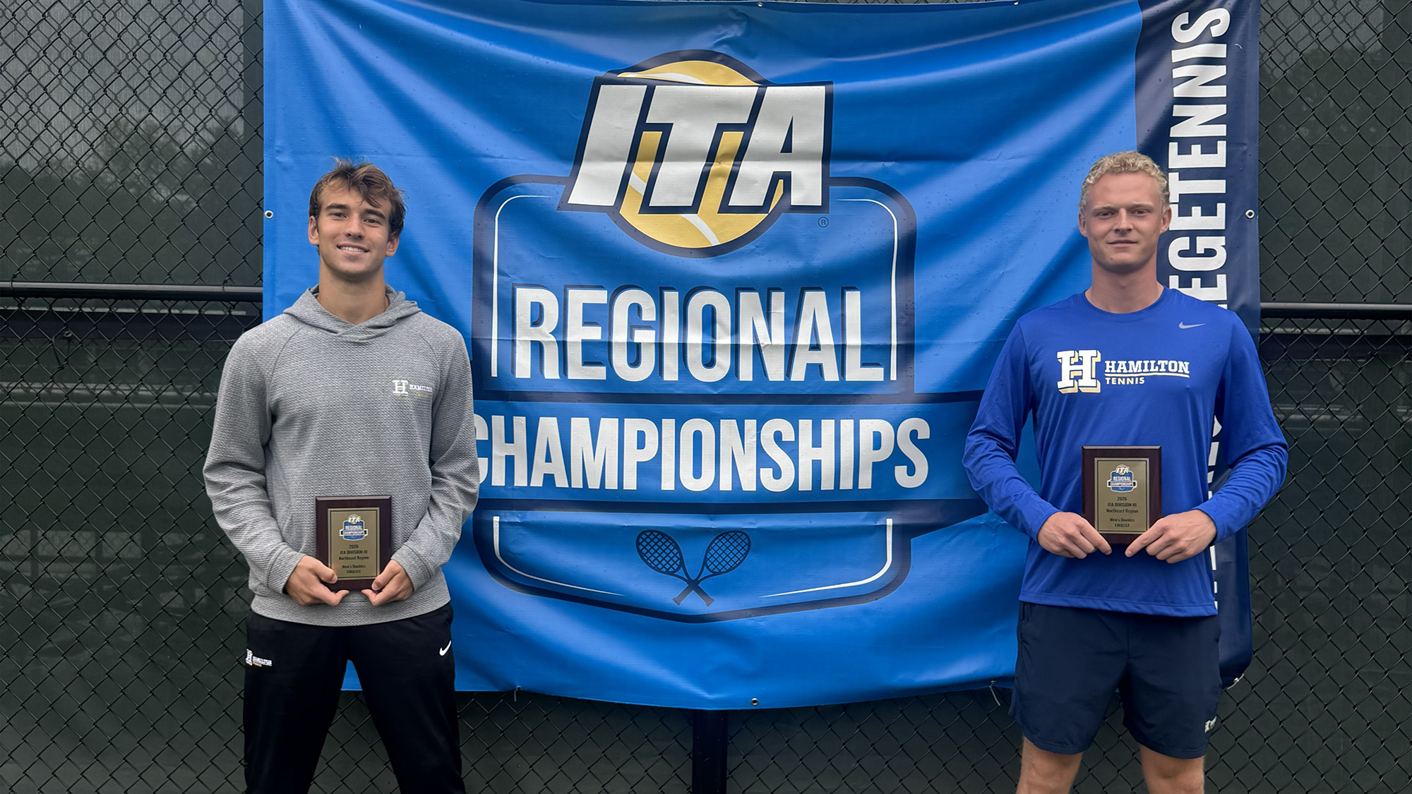 Men's Tennis players Alexei Katelevsky and Filip Moller pose with their runner-up plaques in front of the ITA regional championship banner