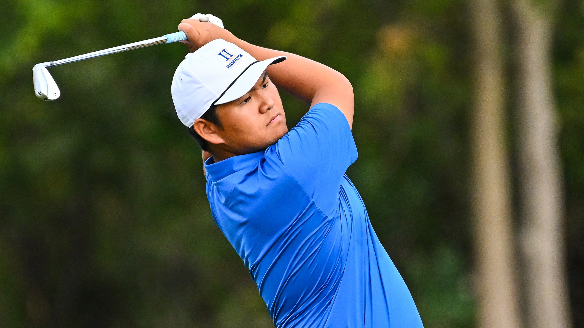 Jonathan Moon watches his iron shot on the driving range at golf practice in September 2025