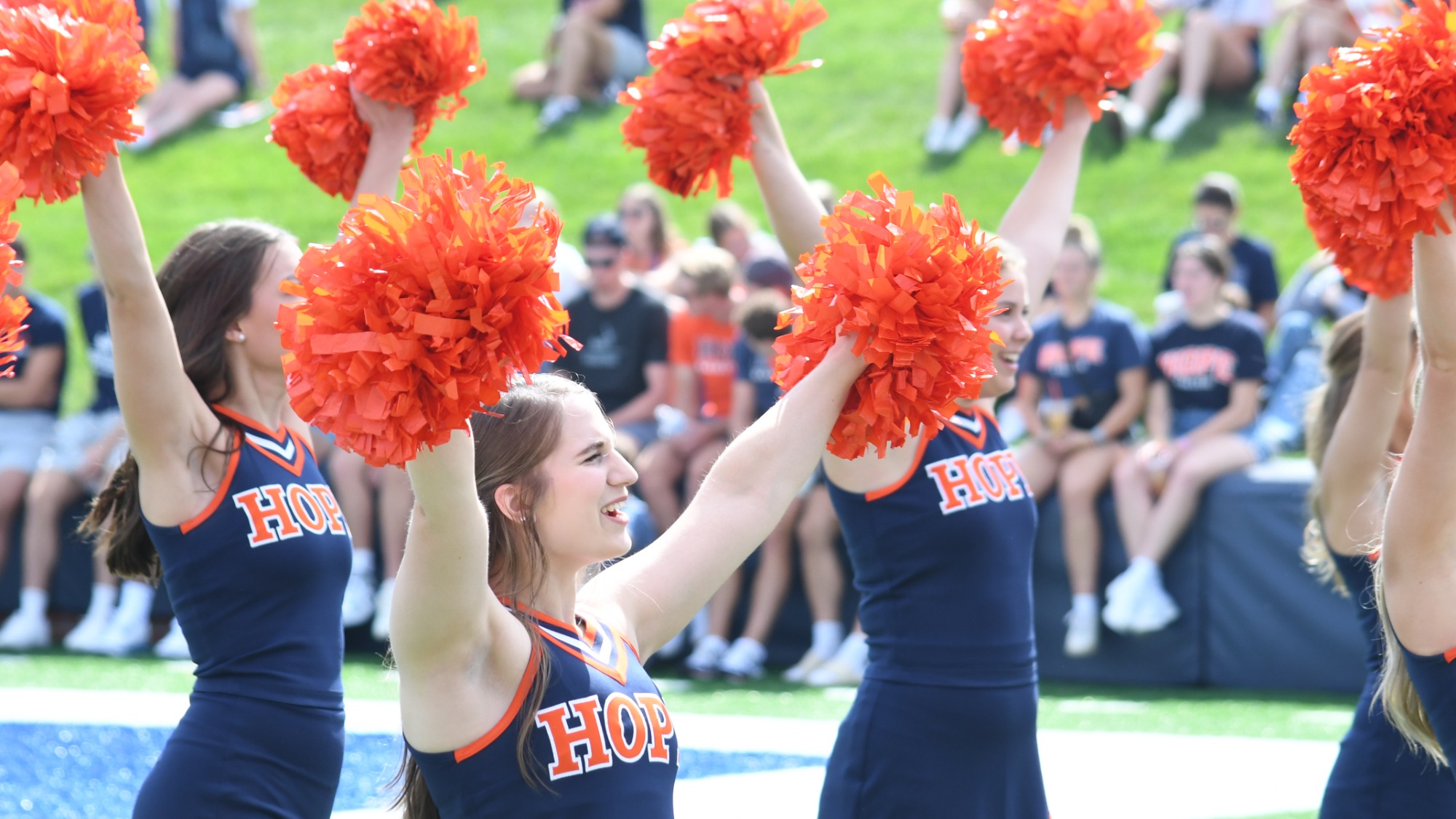 Hope College cheerleaders performing during a football game vs. Loras.