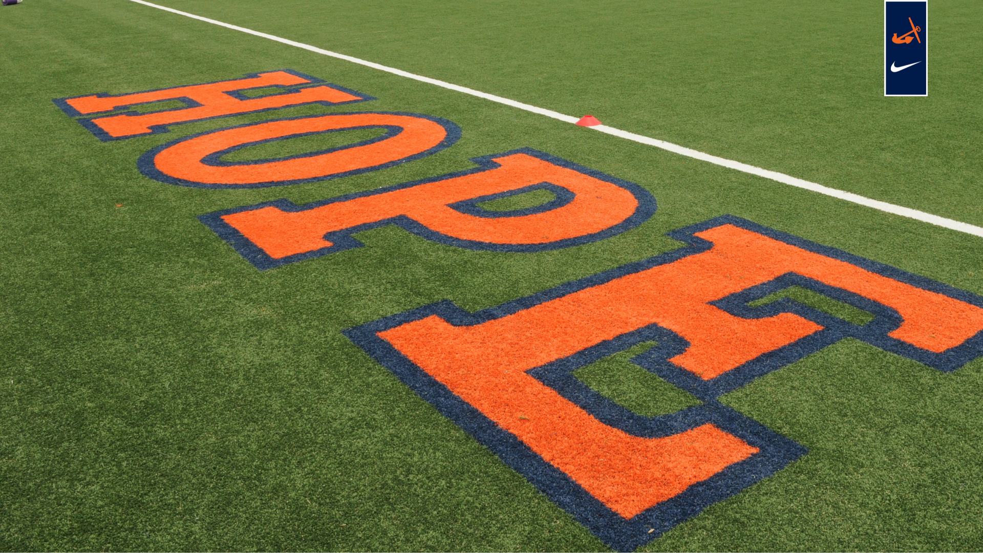Hope spelled out in orange on the green turf at Van Andel Soccer Stadium.