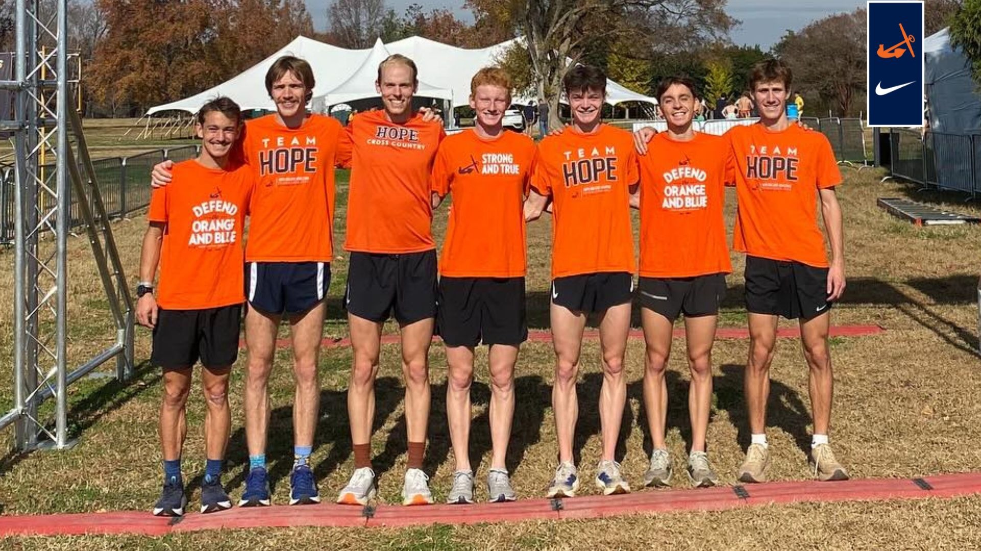 Seven Hope men's cross country runners stand at the finish line.