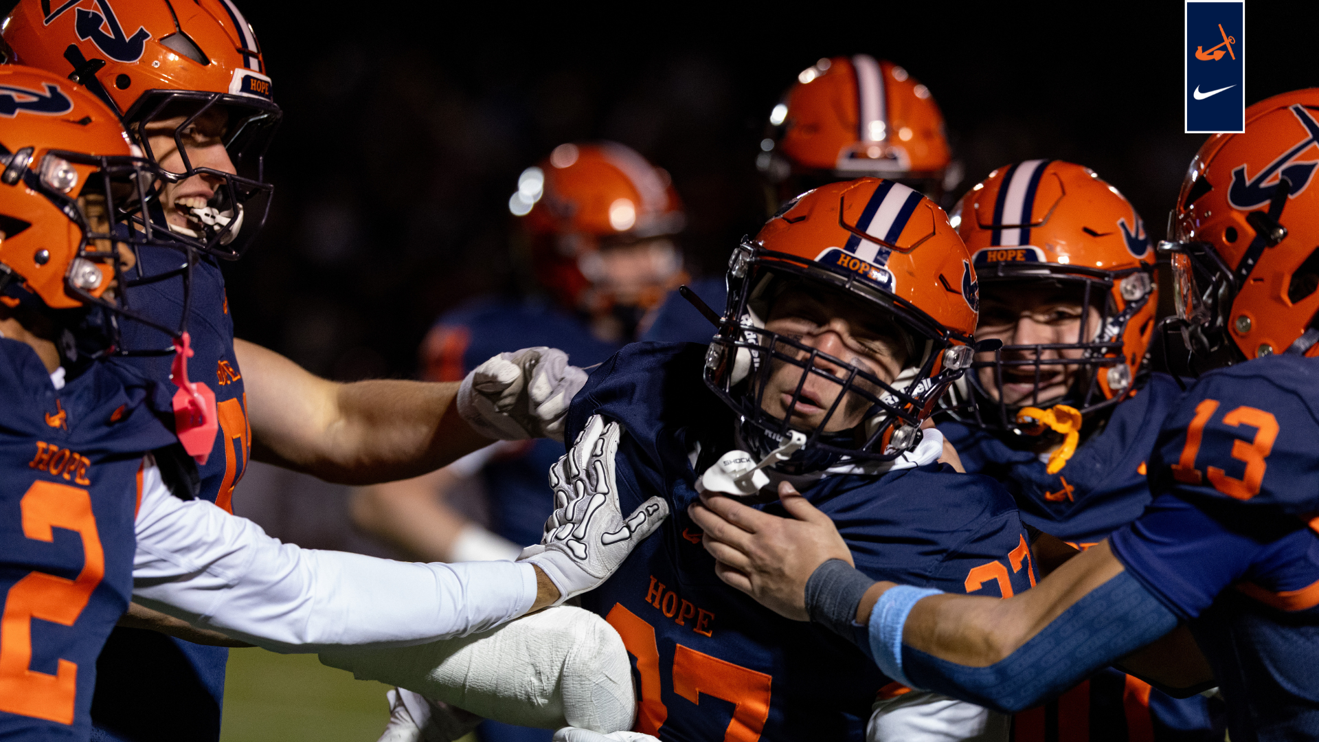 Hope football players celebrate after an interception.