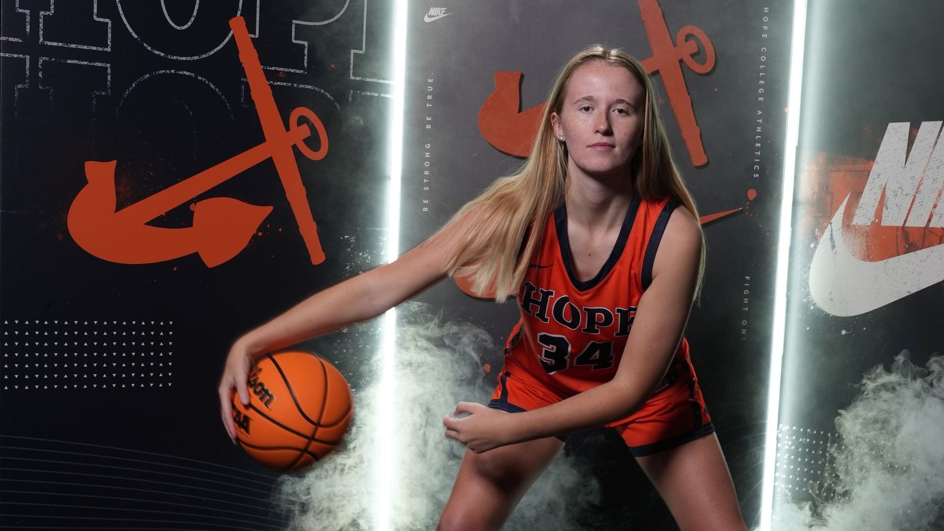 Maddie Petroelje dribbles a basketball.