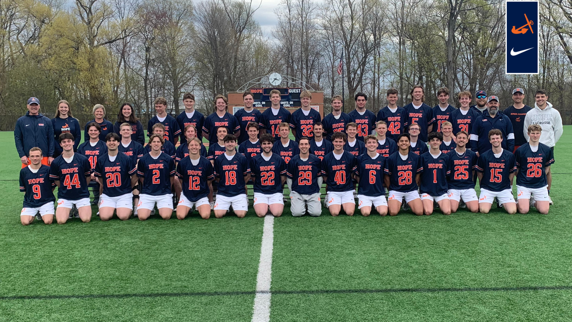 The Hope College men's lacrosse team photo pose together on the field.