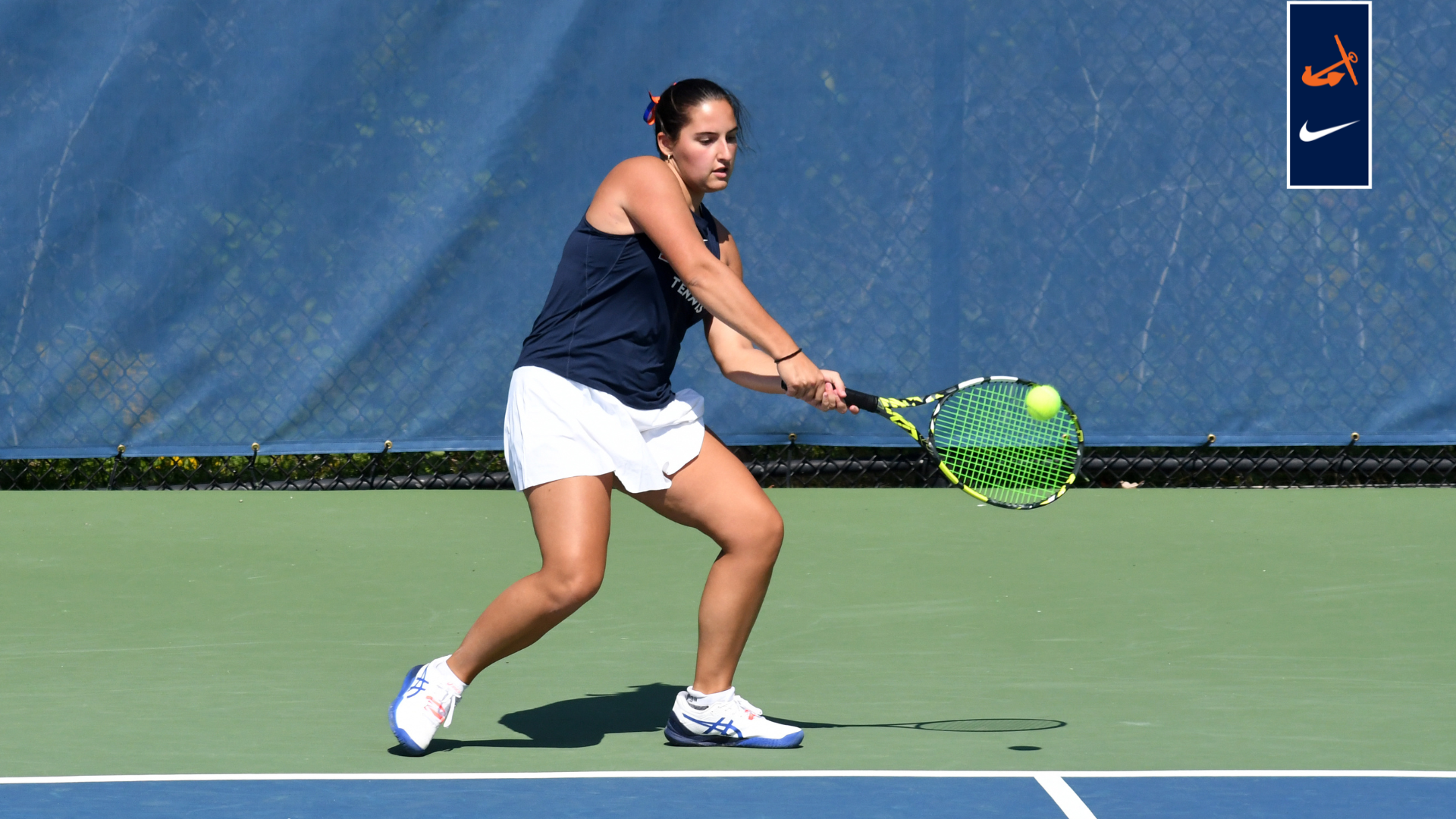 Sophia Grzesiak hits a backhand during a tennis match.