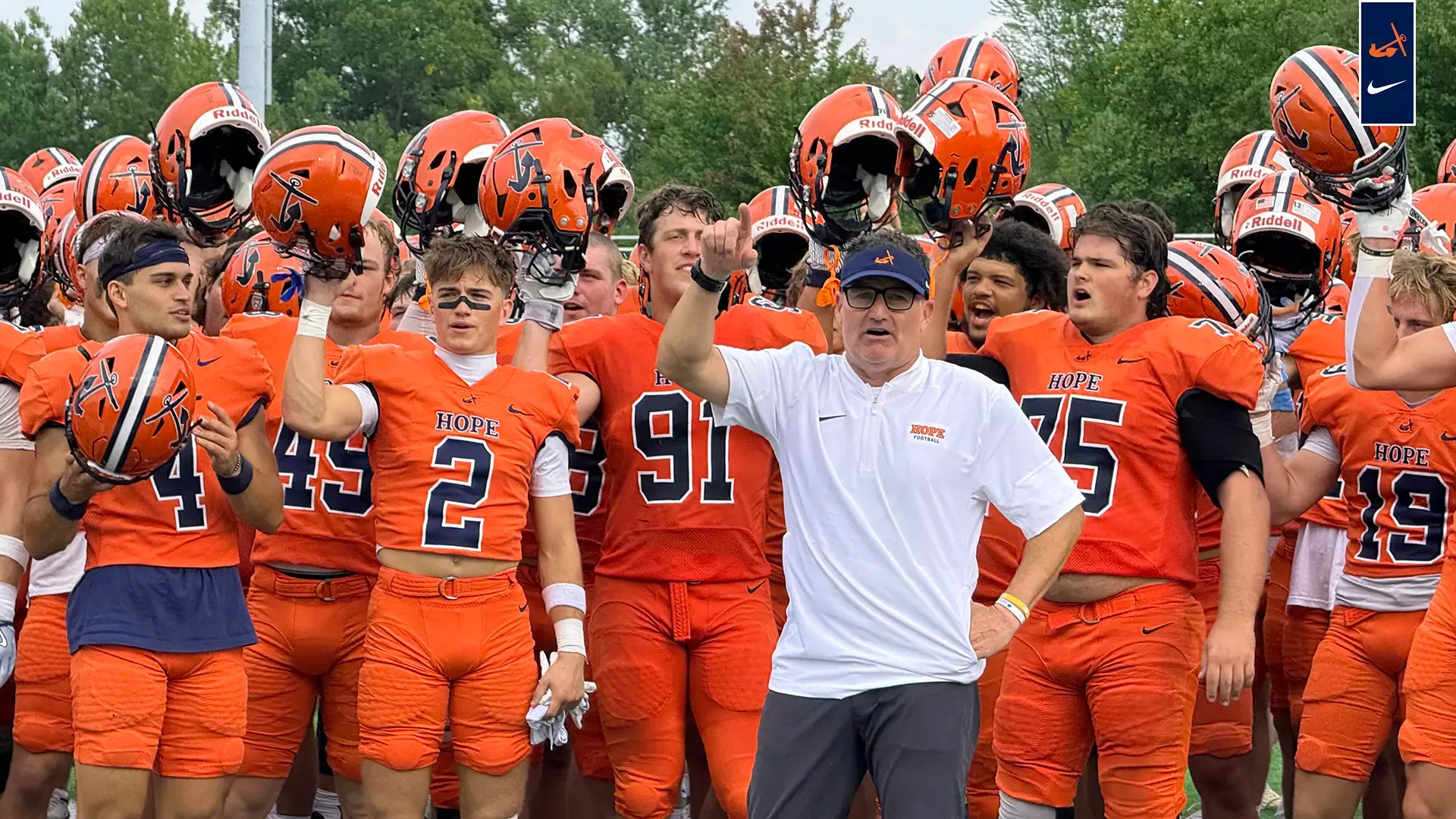 Coach Peter Stuursma leads the team in singing the Hope College Fight Song after a game victory