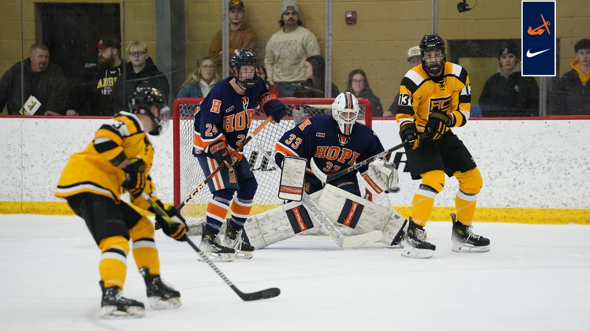 Right wing Brady Kingsbury and goaltender Sebastian Wigfield look for the puck.