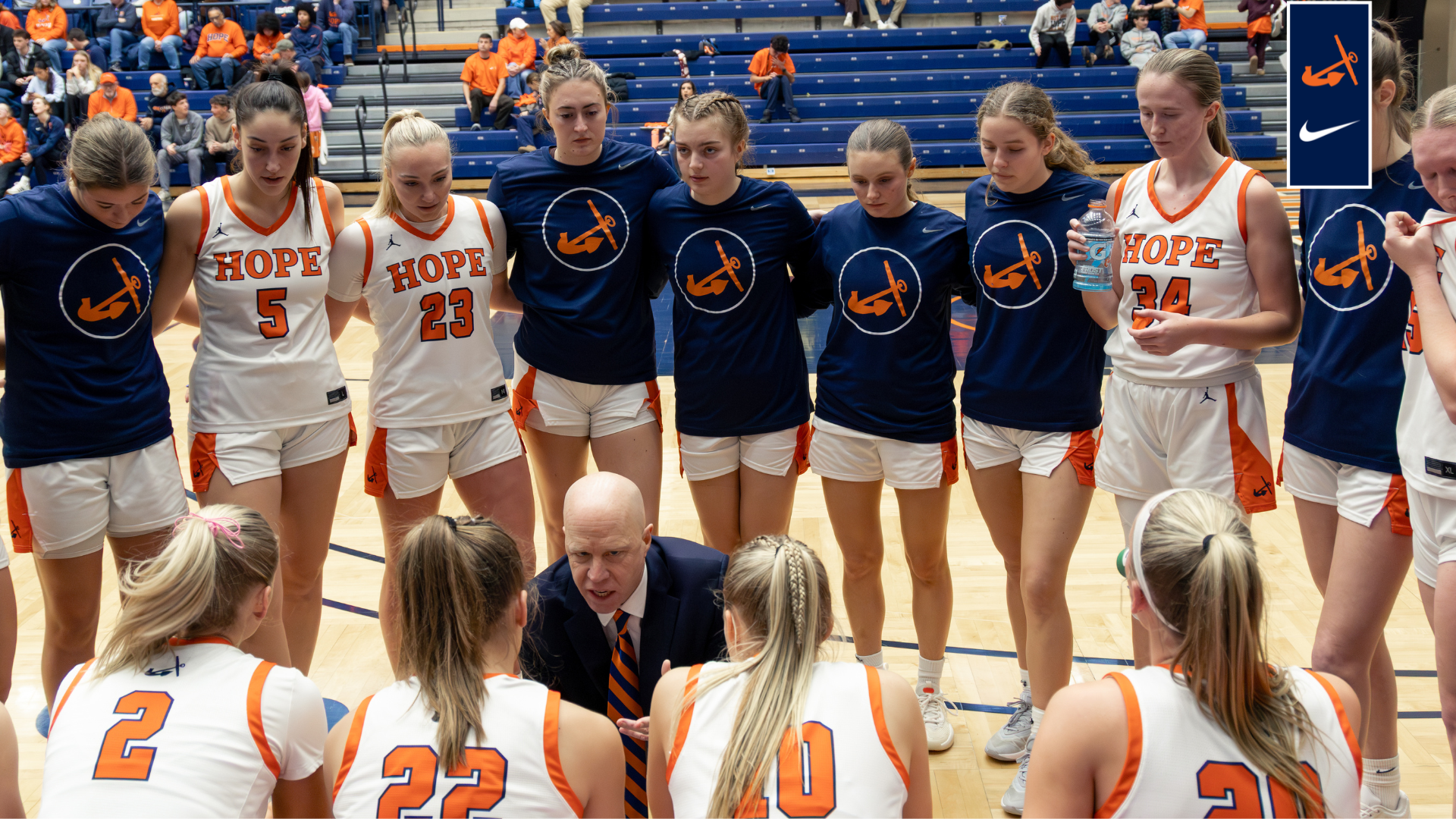 Members of the women's basketball team look on during a timeout