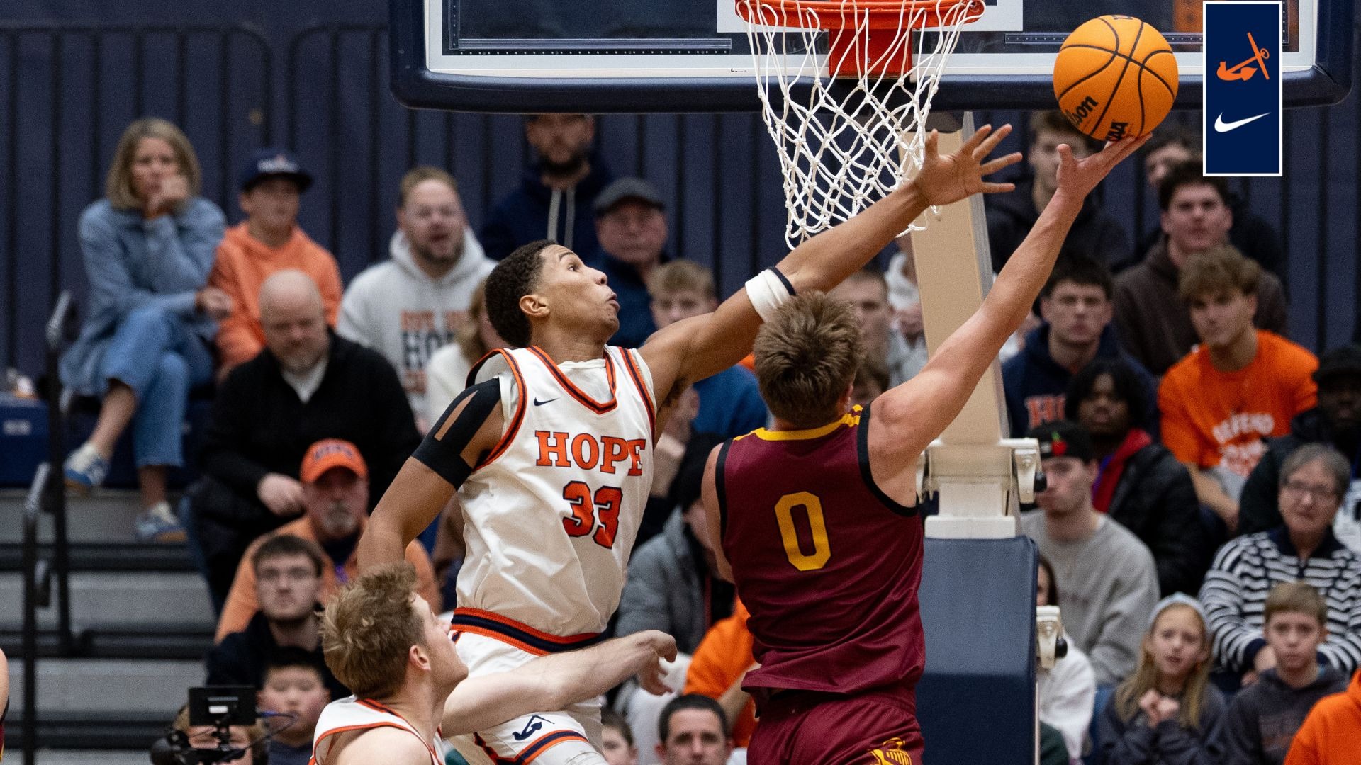 Orion Yant tries to block a Calvin shot at De Vos Fieldhouse.