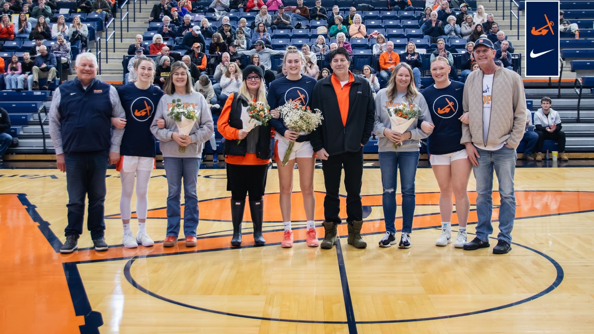 Lauren Leach, Lily Miller and Sydney Vis stand on the court with their families.