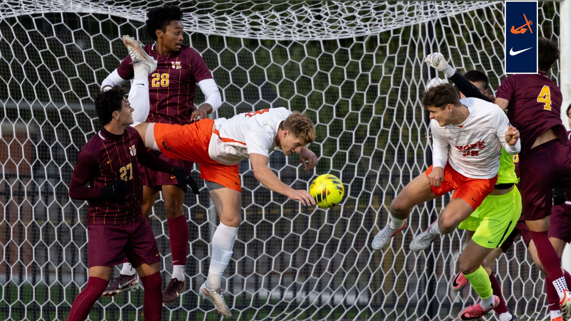 Hope and Calvin men's soccer players battle in front of the net.