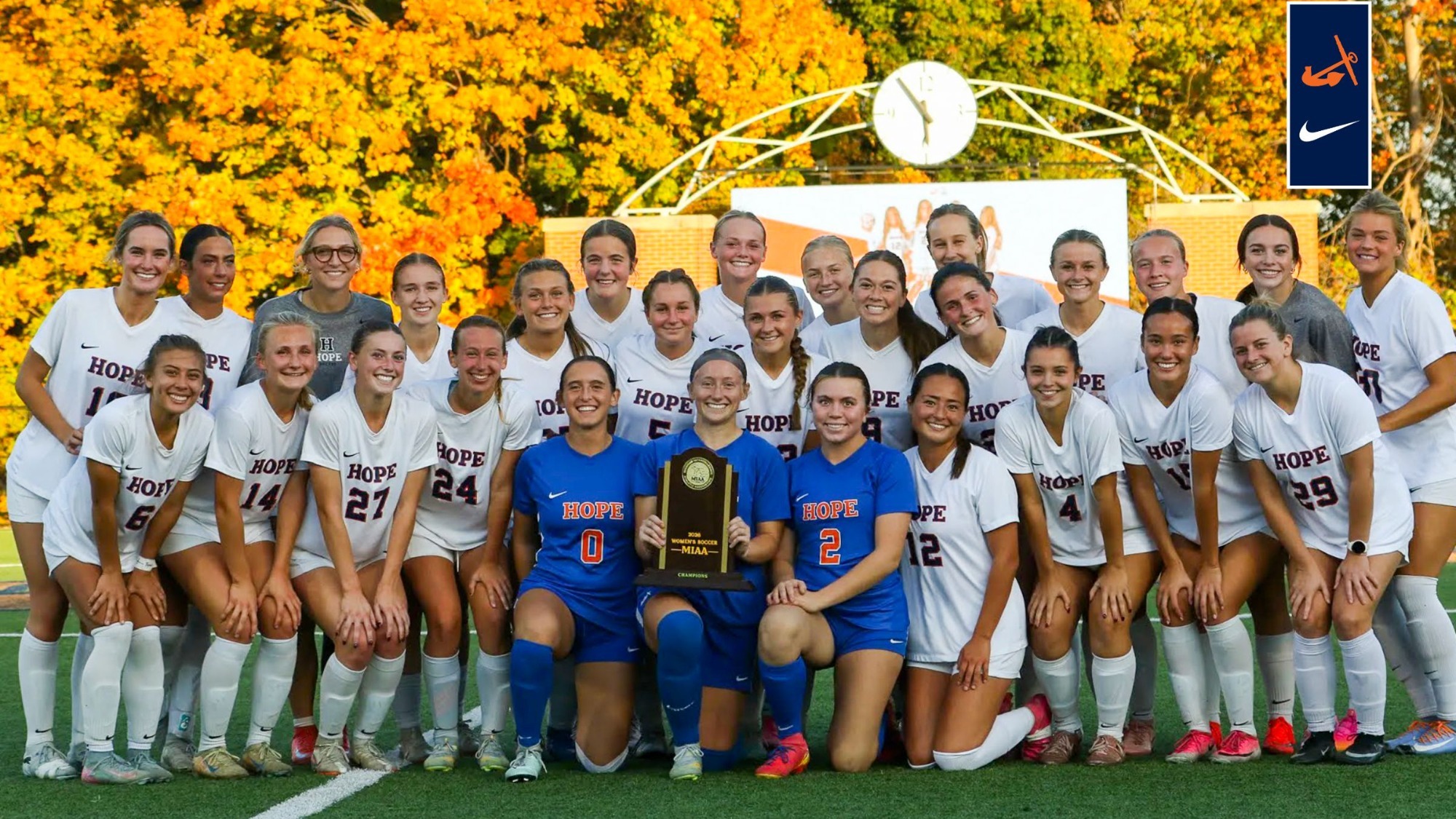 The Hope College women's soccer team holds the MIAA regular-season championship trophy.