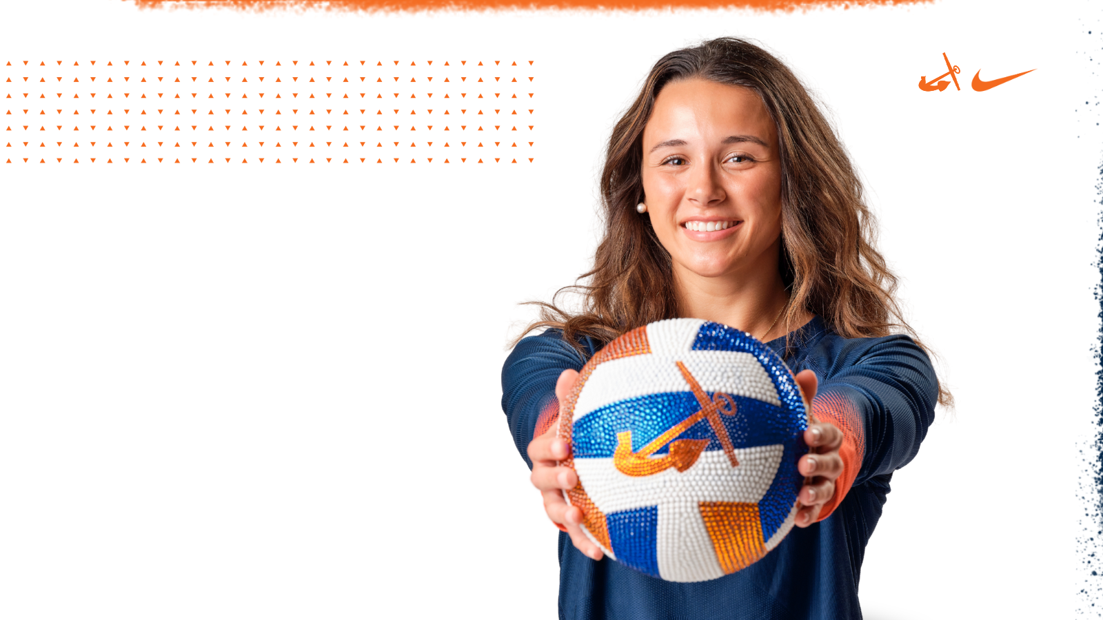 Maddie Ostrander holds a bedazzled Hope volleyball