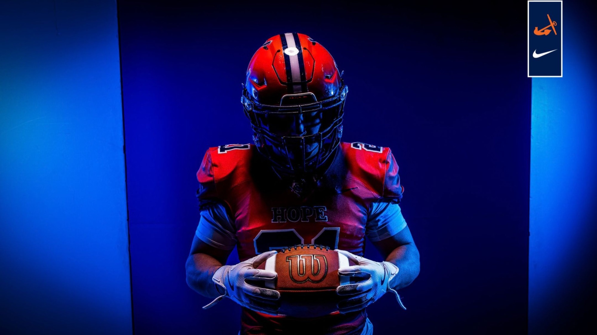 Trey Goike holds a football.