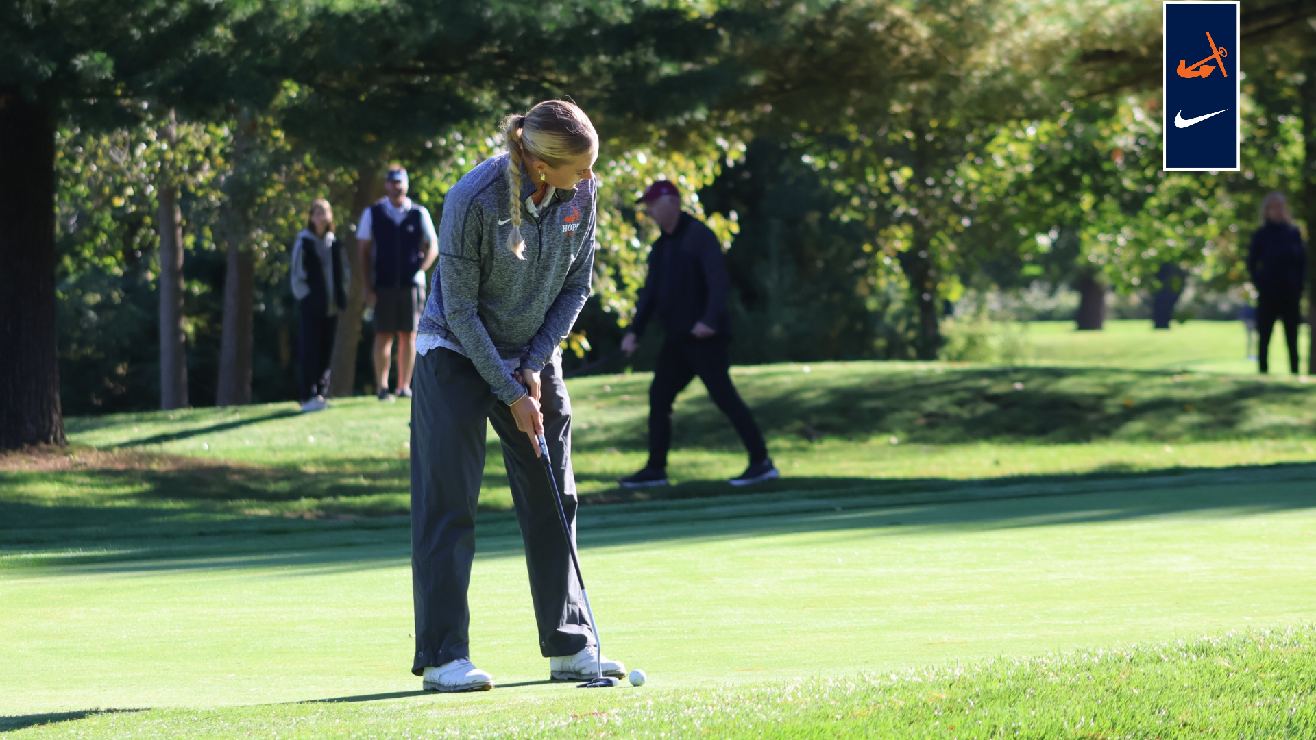 women's golfer lines up a putt