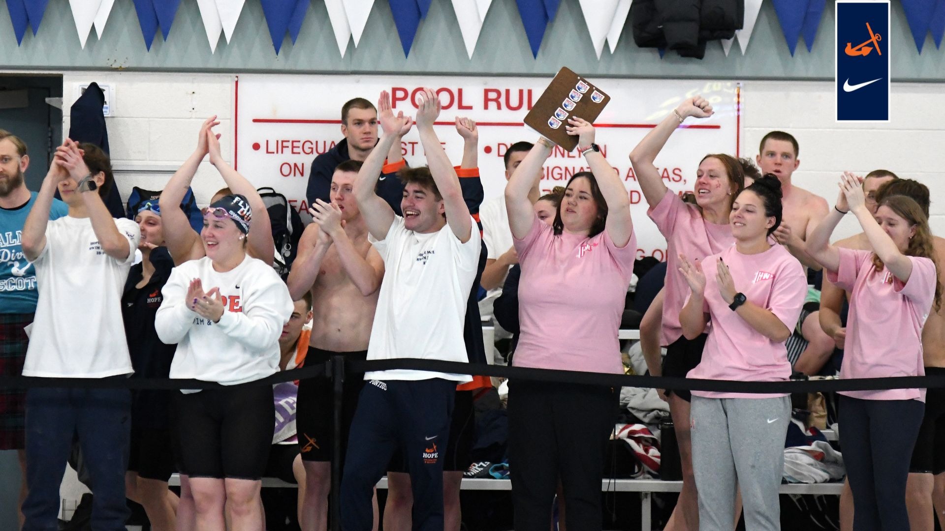 Hope coaches and swimmers cheer during the MIAA Championships at the Holland Aquatic Center.