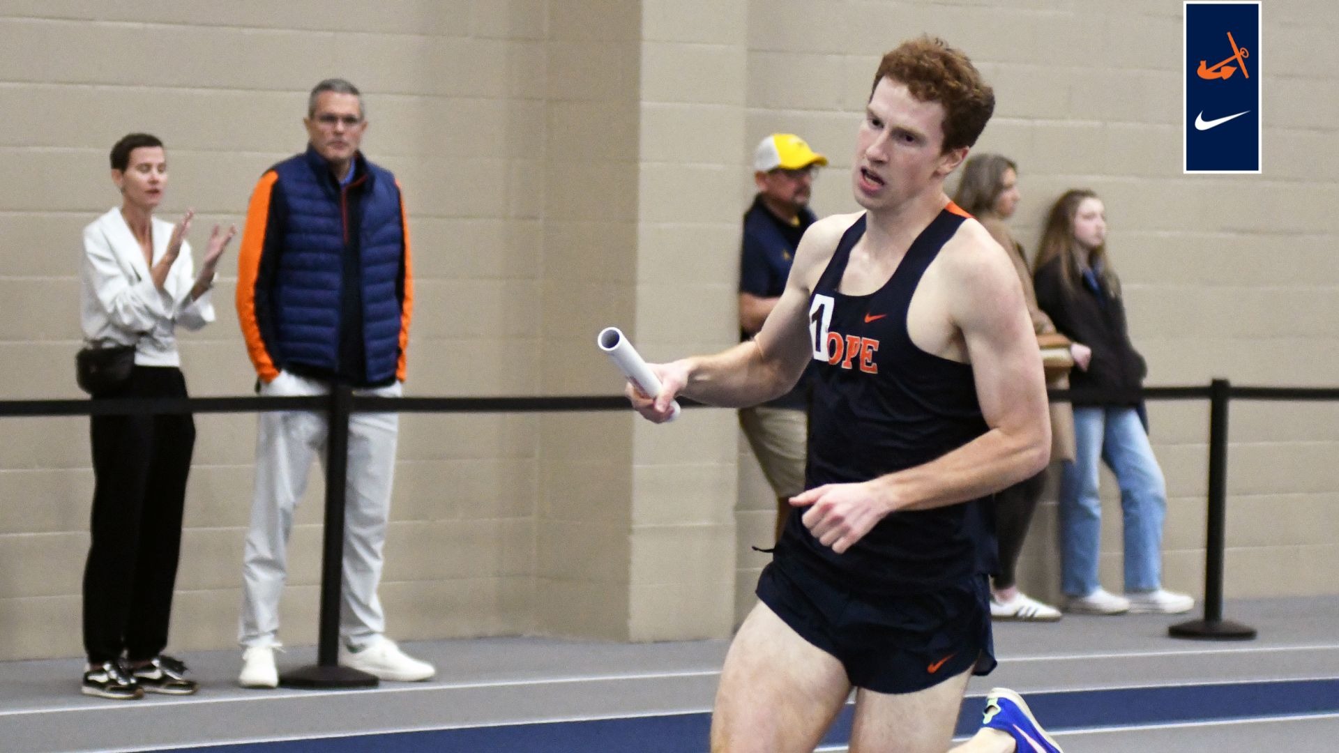 Carter Dean runs a relay at the MIAA Indoor Championships