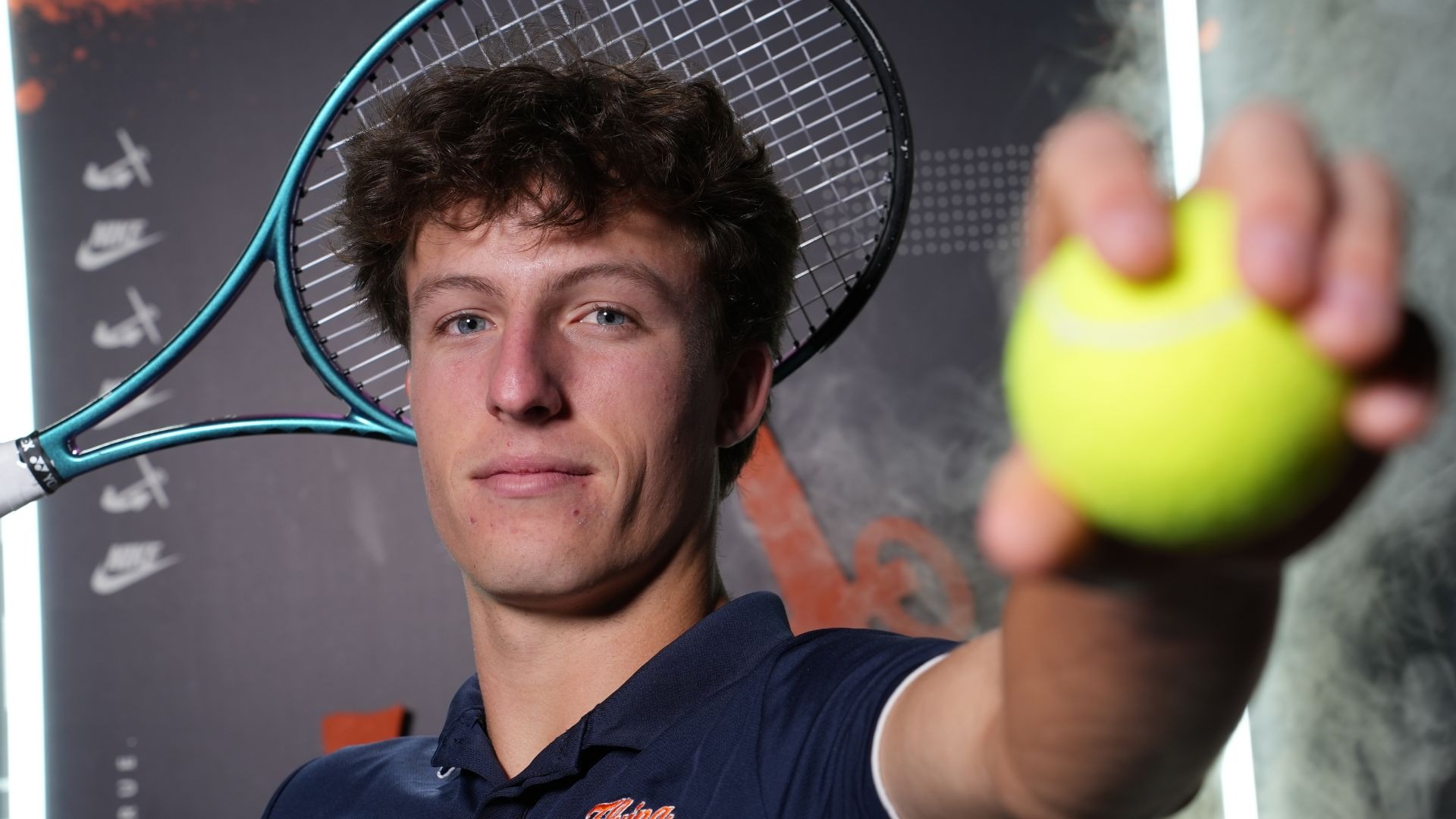 Elliot Dozeman holds a tennis ball.