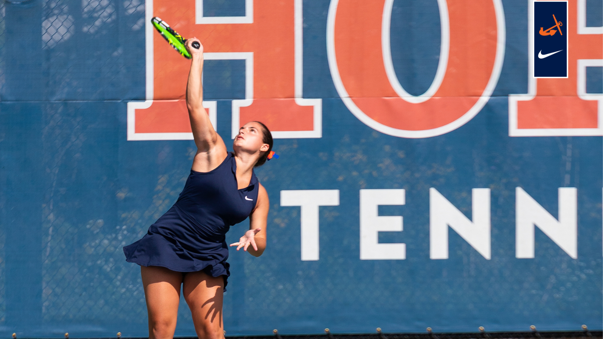 A Hope College tennis player looks to serve the ball