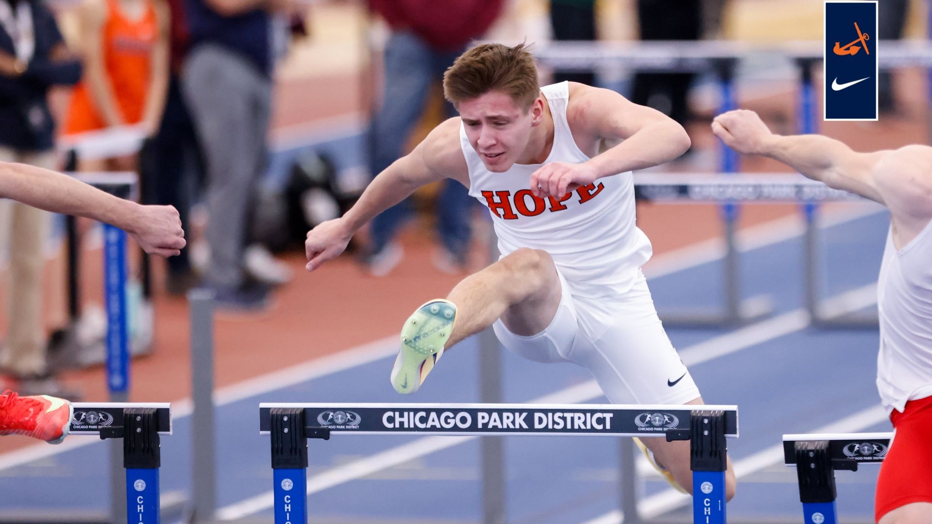 A Hope men's track runner clears a hurdle.