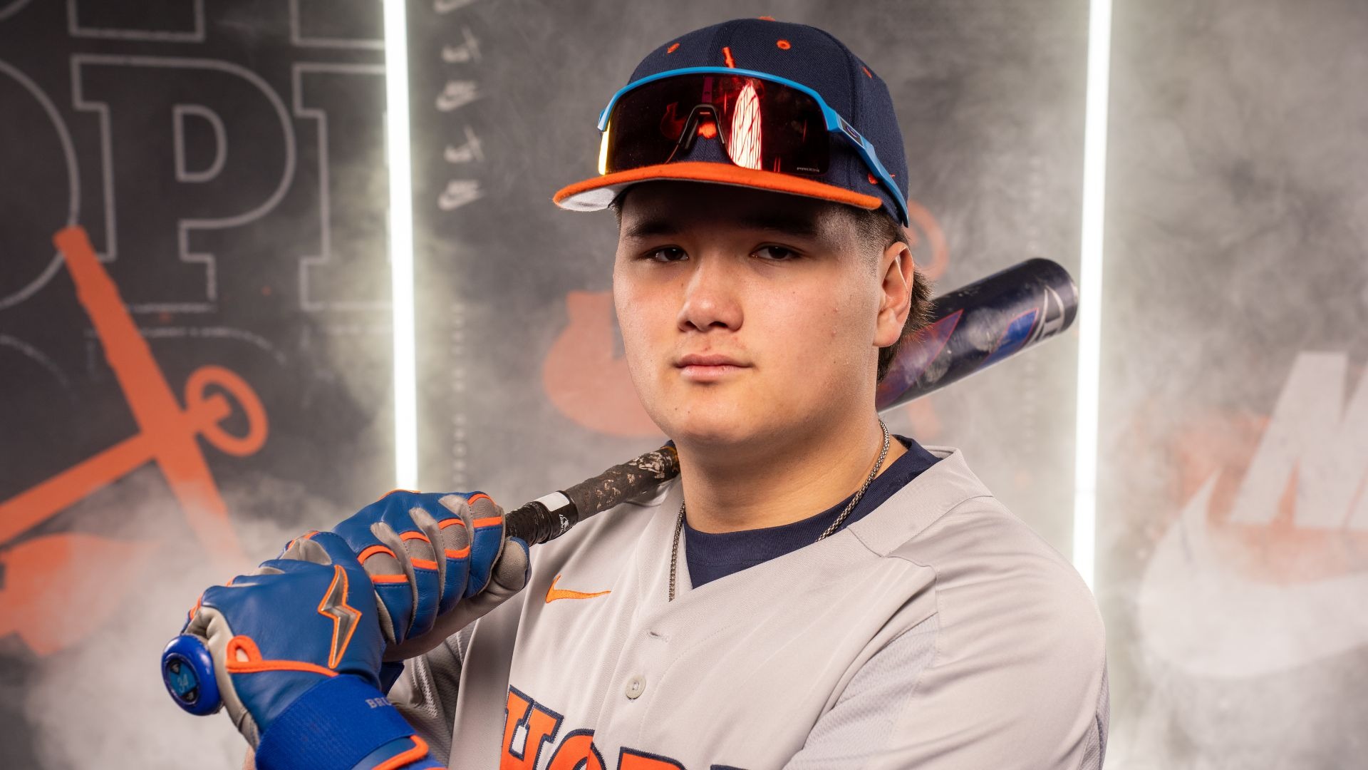 Granden Kinnie holds a baseball bat on his shoulder.