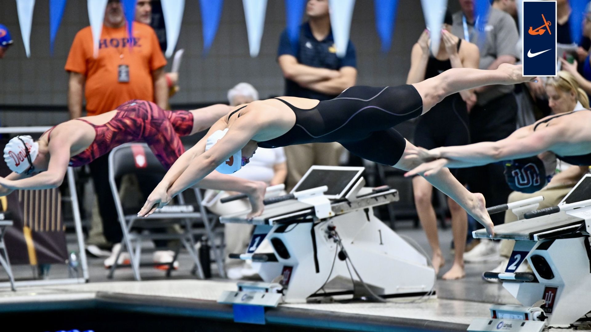 Swimmer Laurel Wasiniak leaps off the starting blocks.