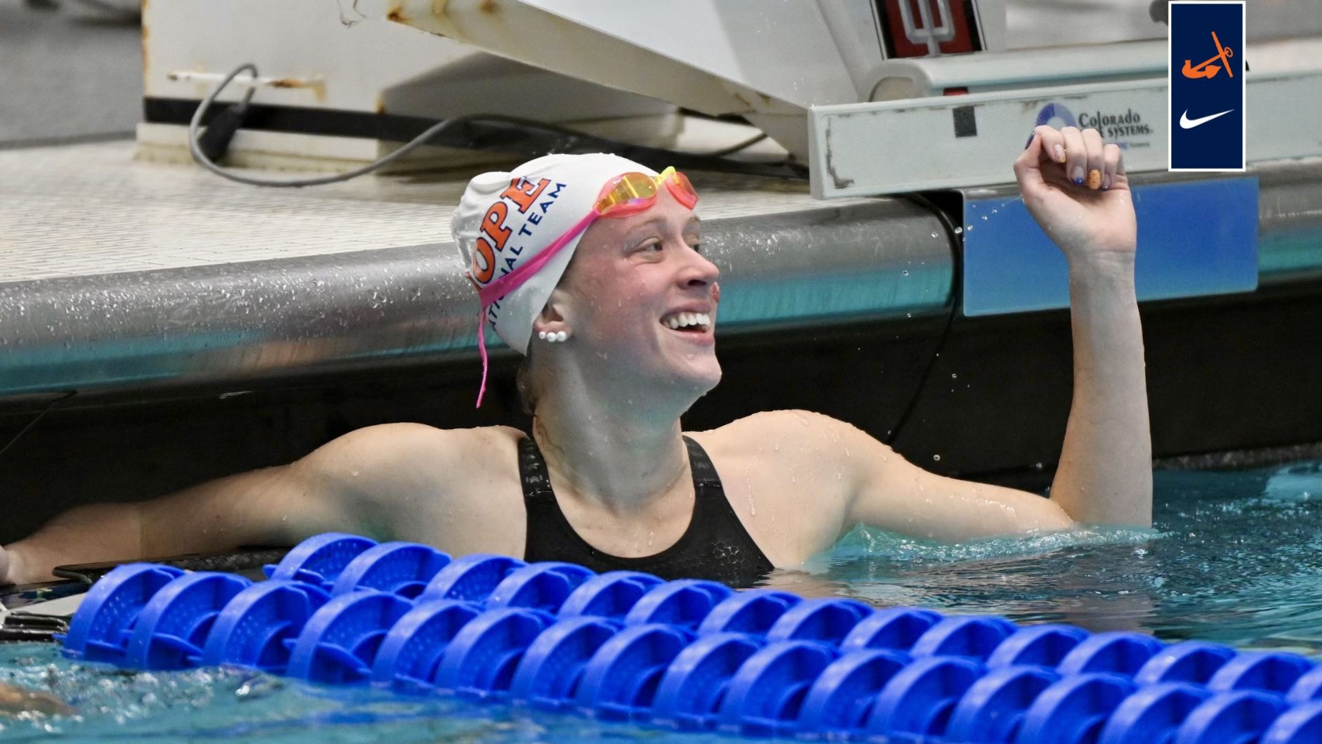 Greta Gidley pumps her fist in the pool after a race.