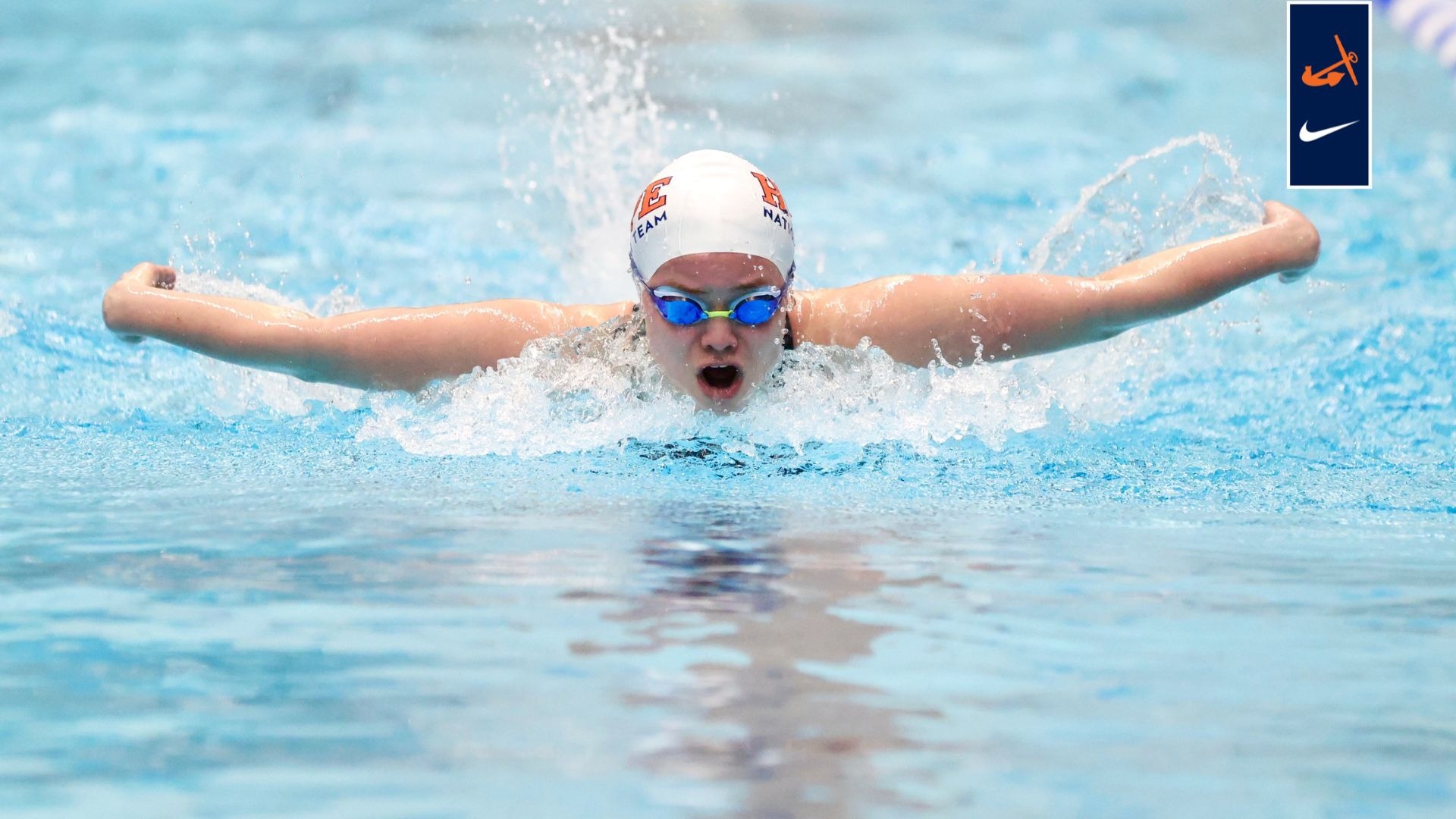A Hope women's swimmer competes in a butterfly race.