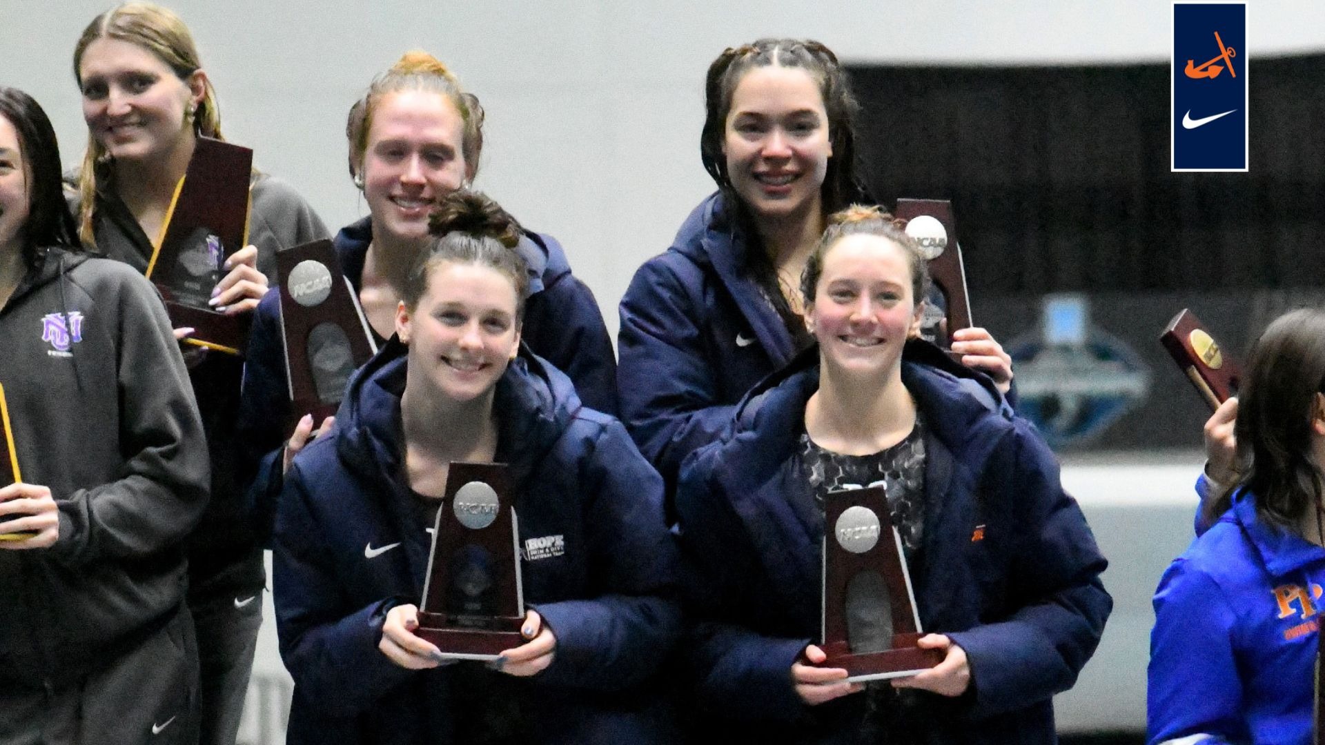 Four Hope swimmers hold NCAA second-place trophies.