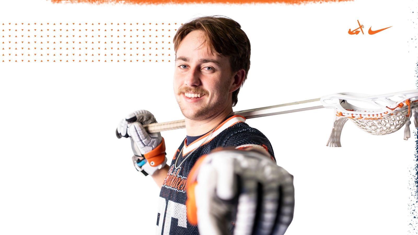 Will Tobias points while holding a lacrosse stick.