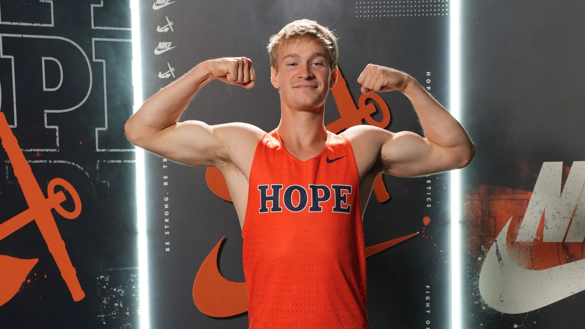 Runner Erickson Kunzler flexes his arms.