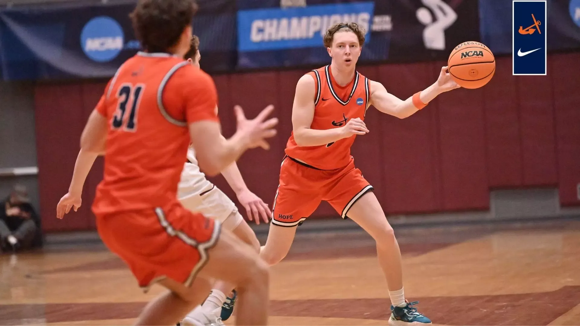 Avery Sanchez passes the basketball to Brendan Cargill against Wisconsin La Crosse.