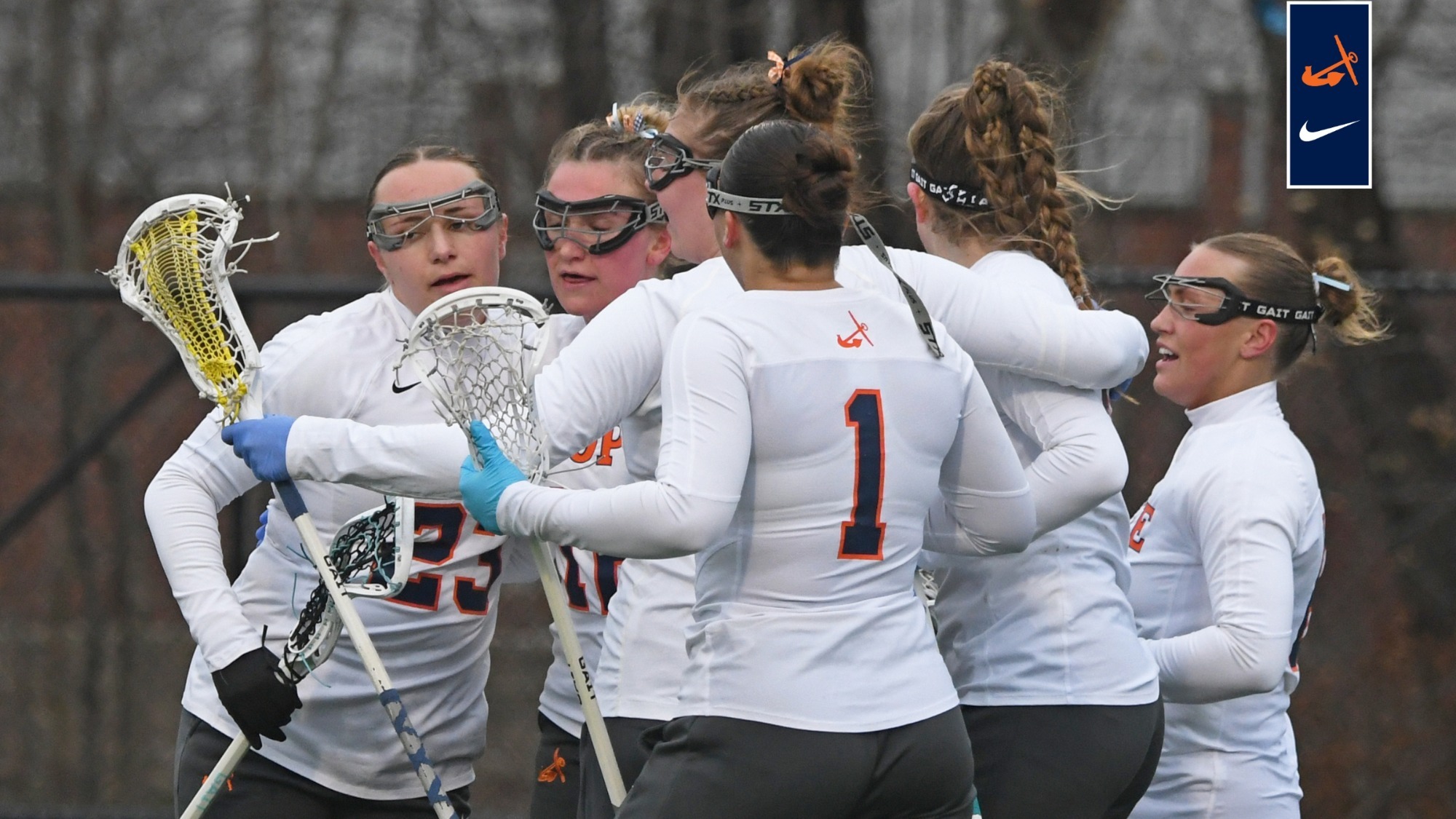 Hope women's lacrosse huddle to celebrate a goal.