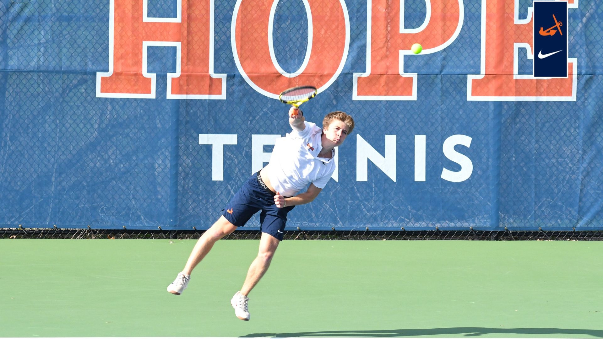 Blake Smith hits an overhand return vs. Alma.