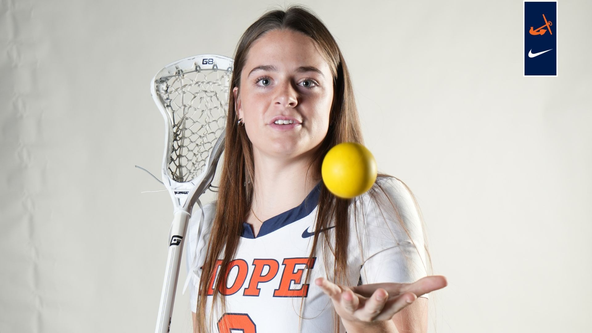 Lucy Harrell flips a lacrosse ball in the air.