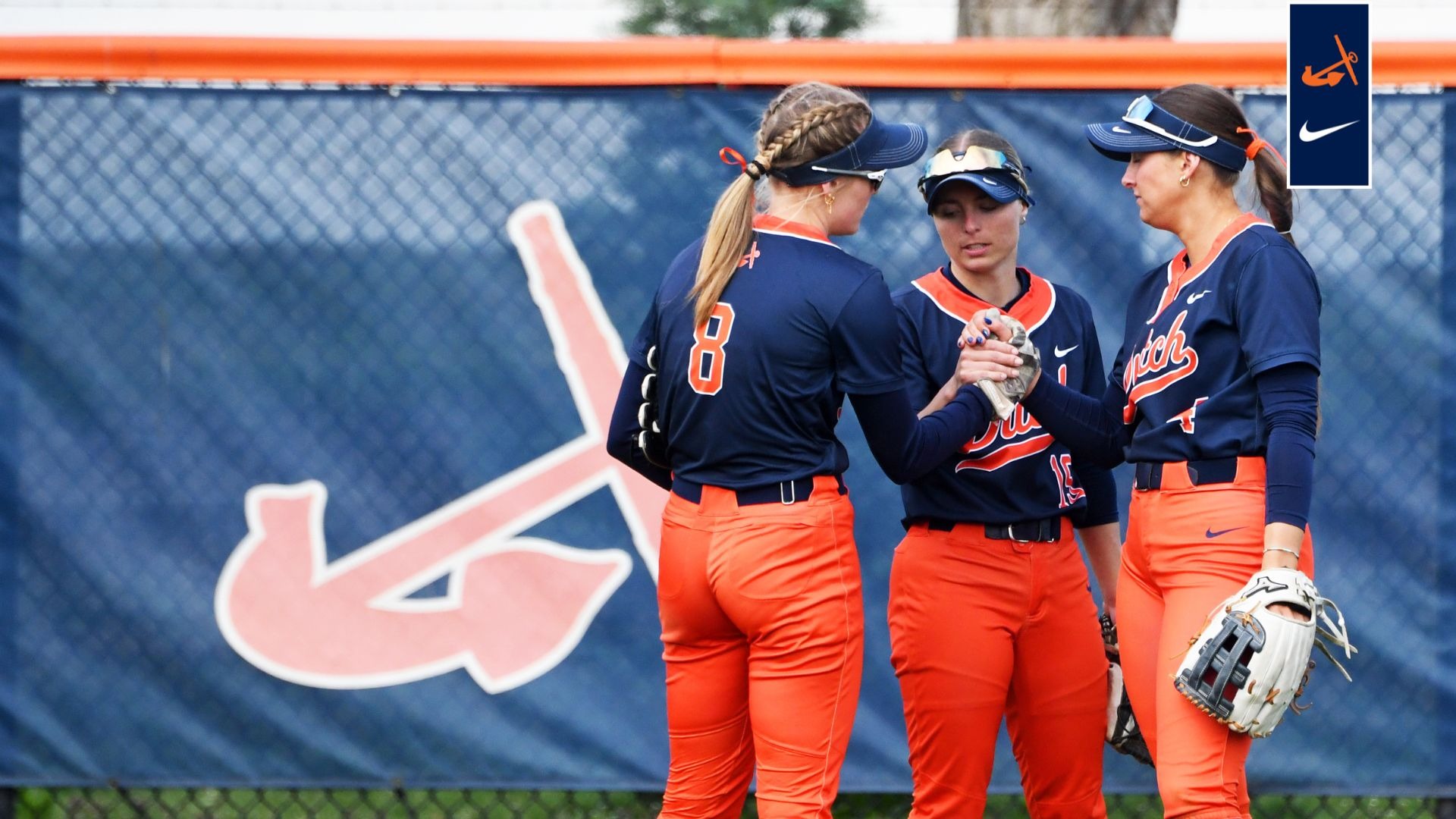 Three Hope outfielders huddle on the field.