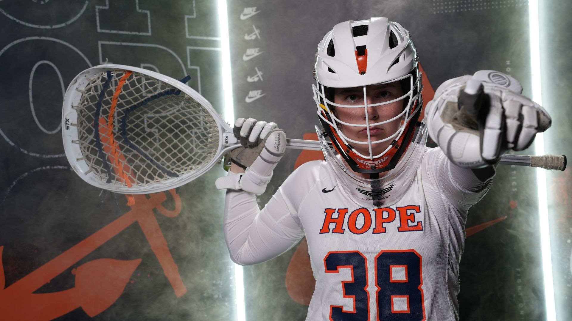 Goalie Samantha Smith points toward the camera.