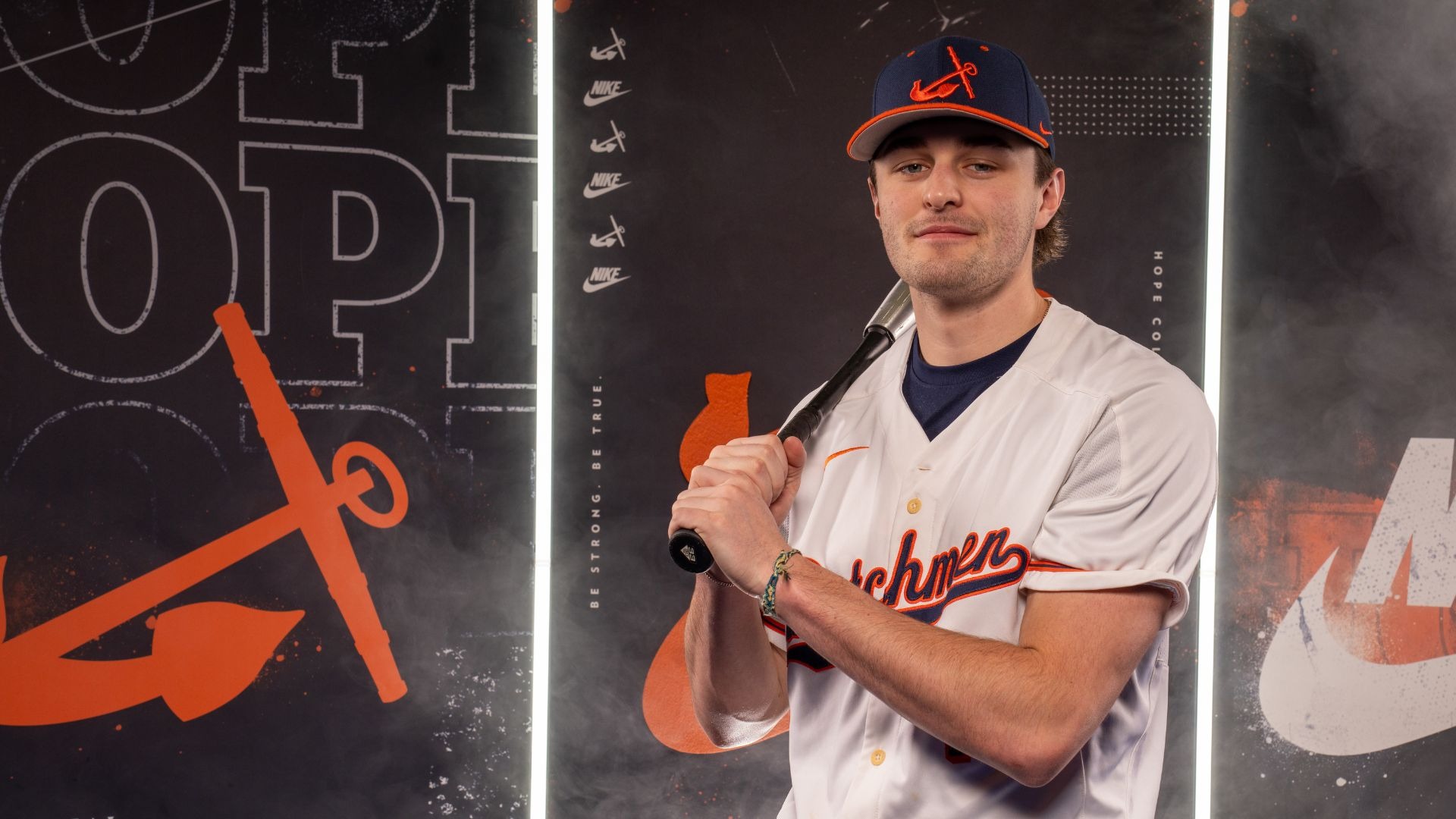 Corbin Bennets holds a baseball bat on his shoulders.