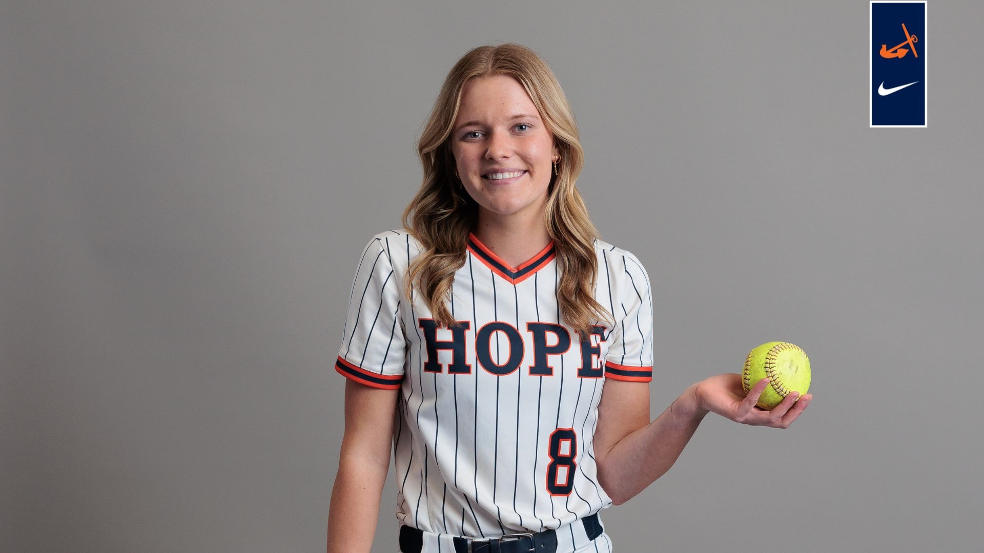Emily Brown holds a softball and a bat.