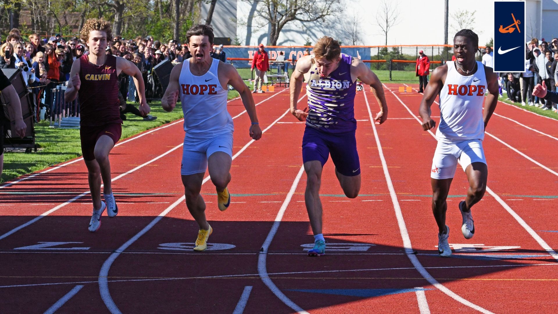 Two Hope men's runners lunge at the finish line.