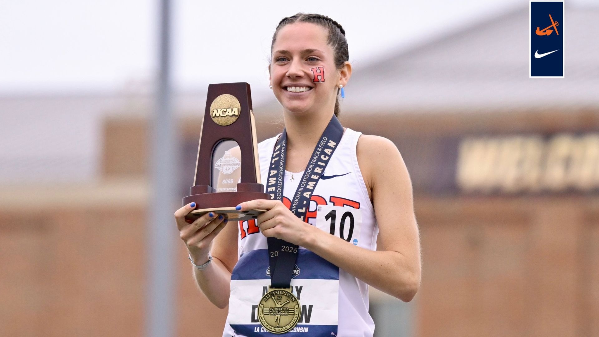 Molly Durow holds a NCAA steeplechase trophy.