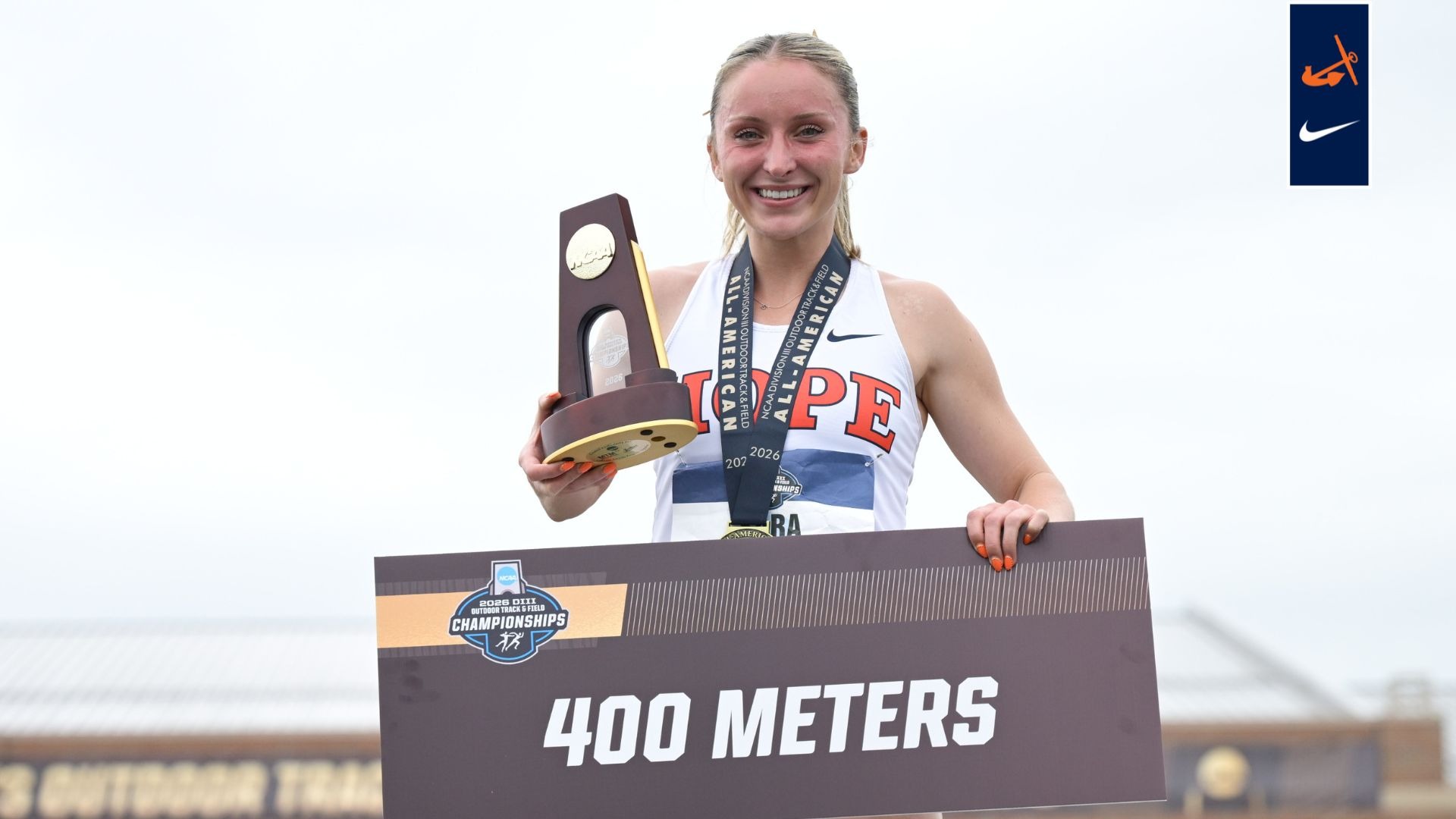 Sara Schermerhorn holds the NCAA title trophy on the podium.