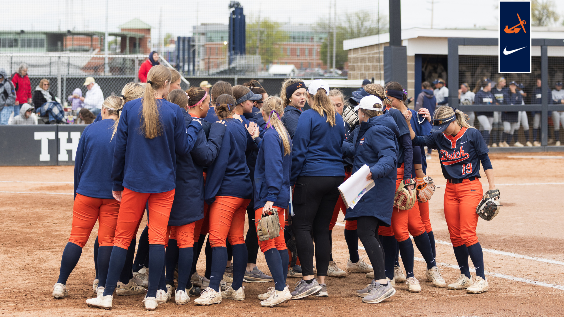 The Hope softball team comes together before an inning 