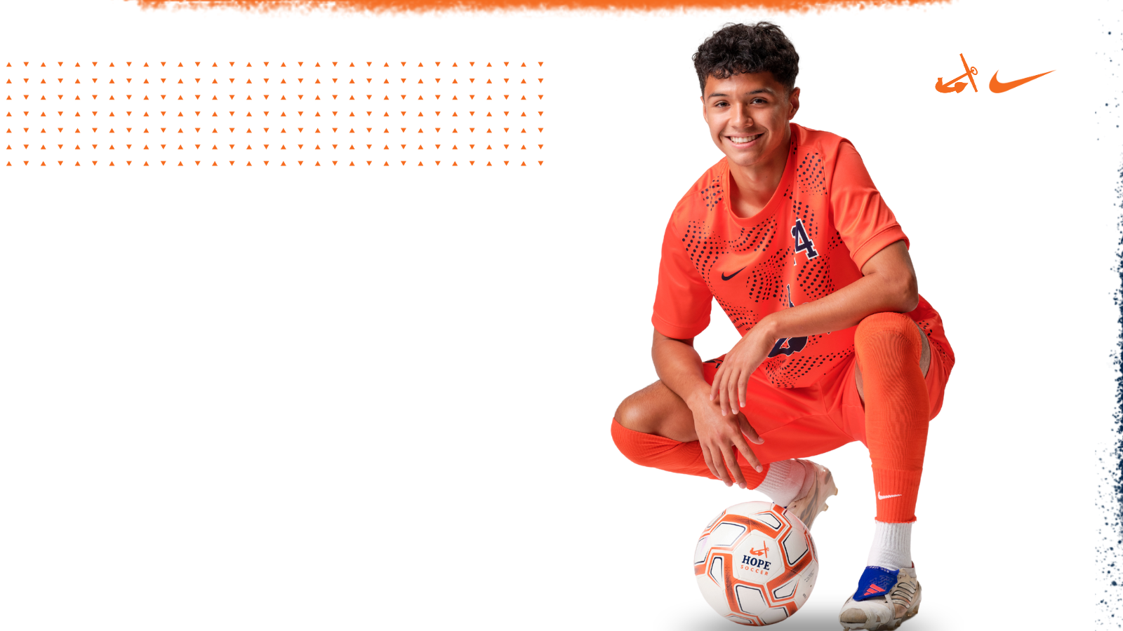 Rayden Dominguez poses for a photo with a soccer ball at his feet.