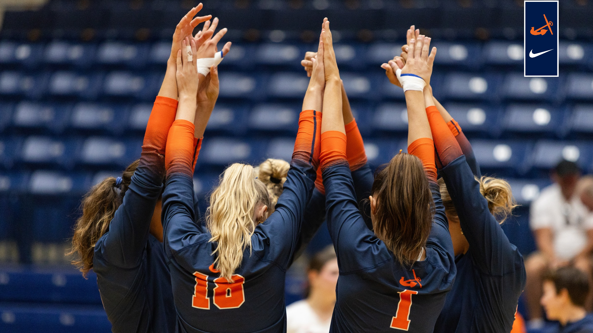 The volleyball team stands together before a game