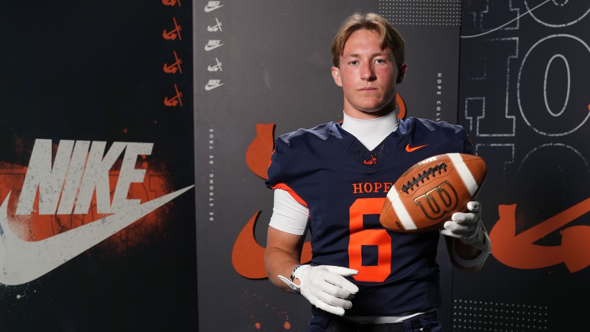 Jonny Rohen-Blanton holds a football.