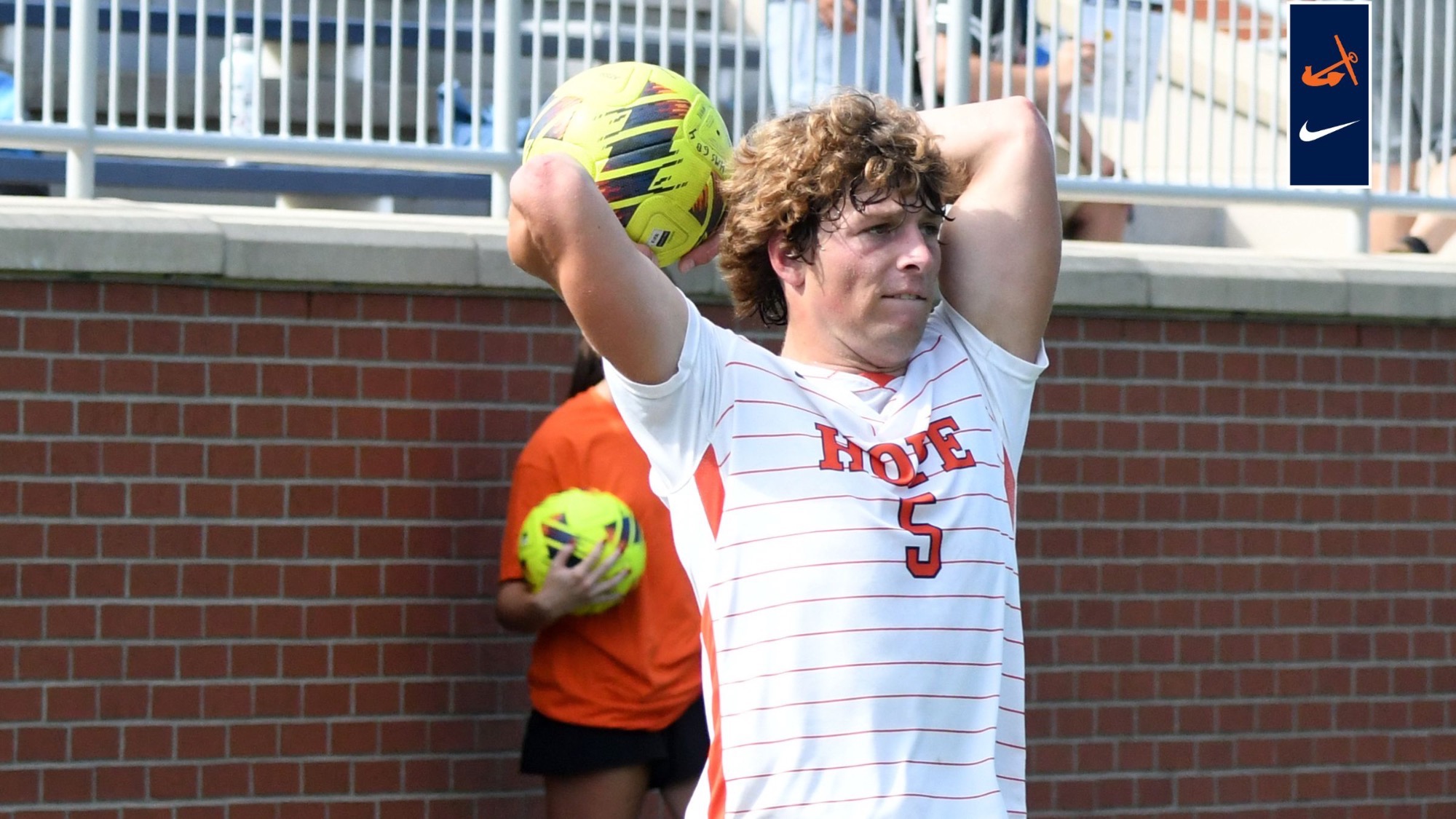 Soccer defender Jack Lowman does a throw in.