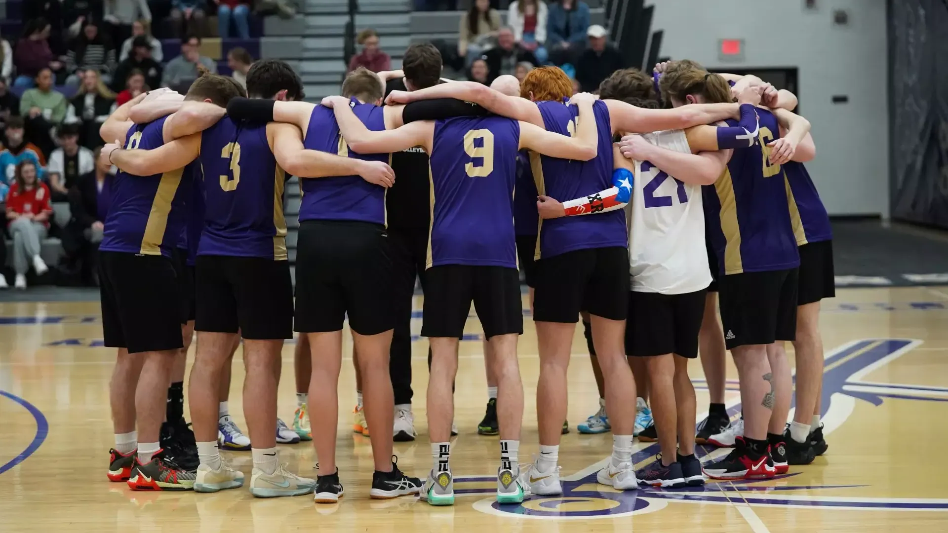 Men's volleyball court huddle
