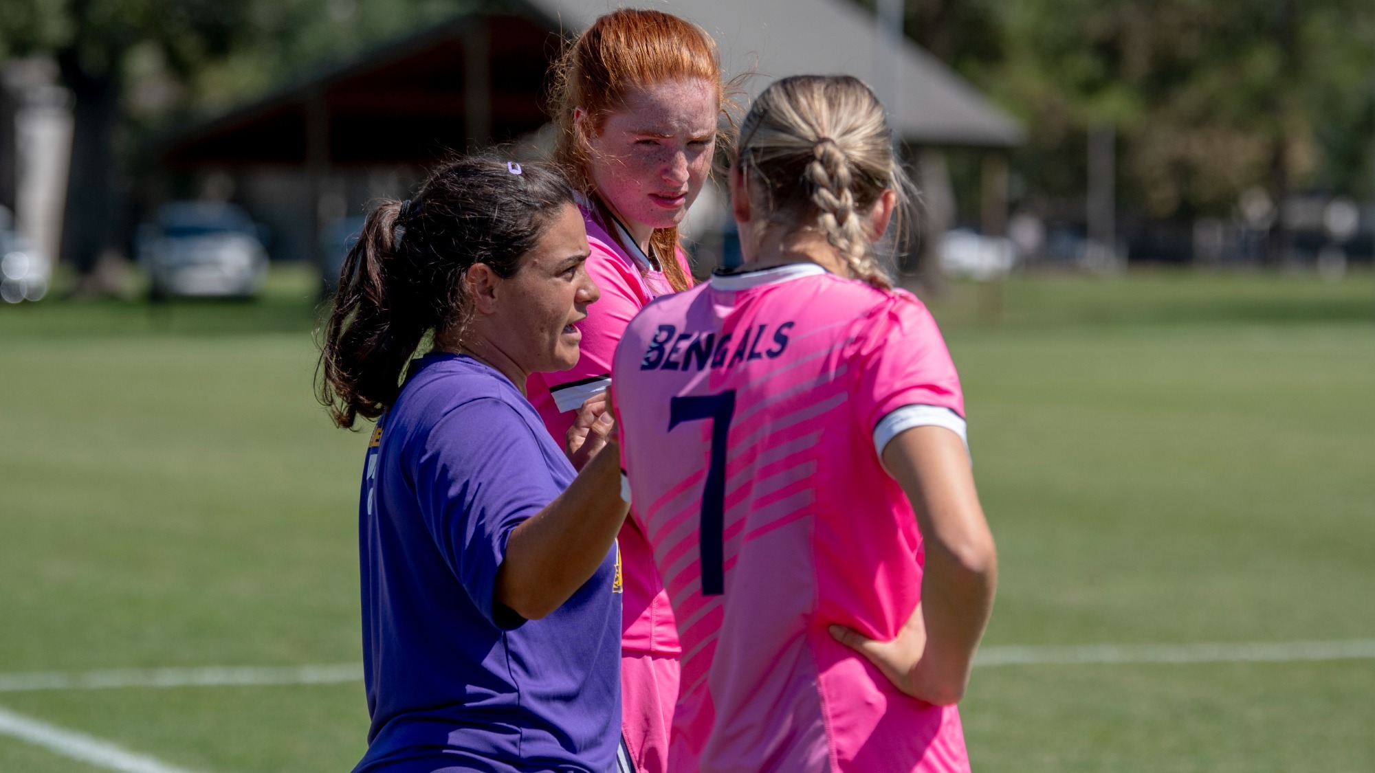 Coach Courtney Murdoch talks to players during a game.