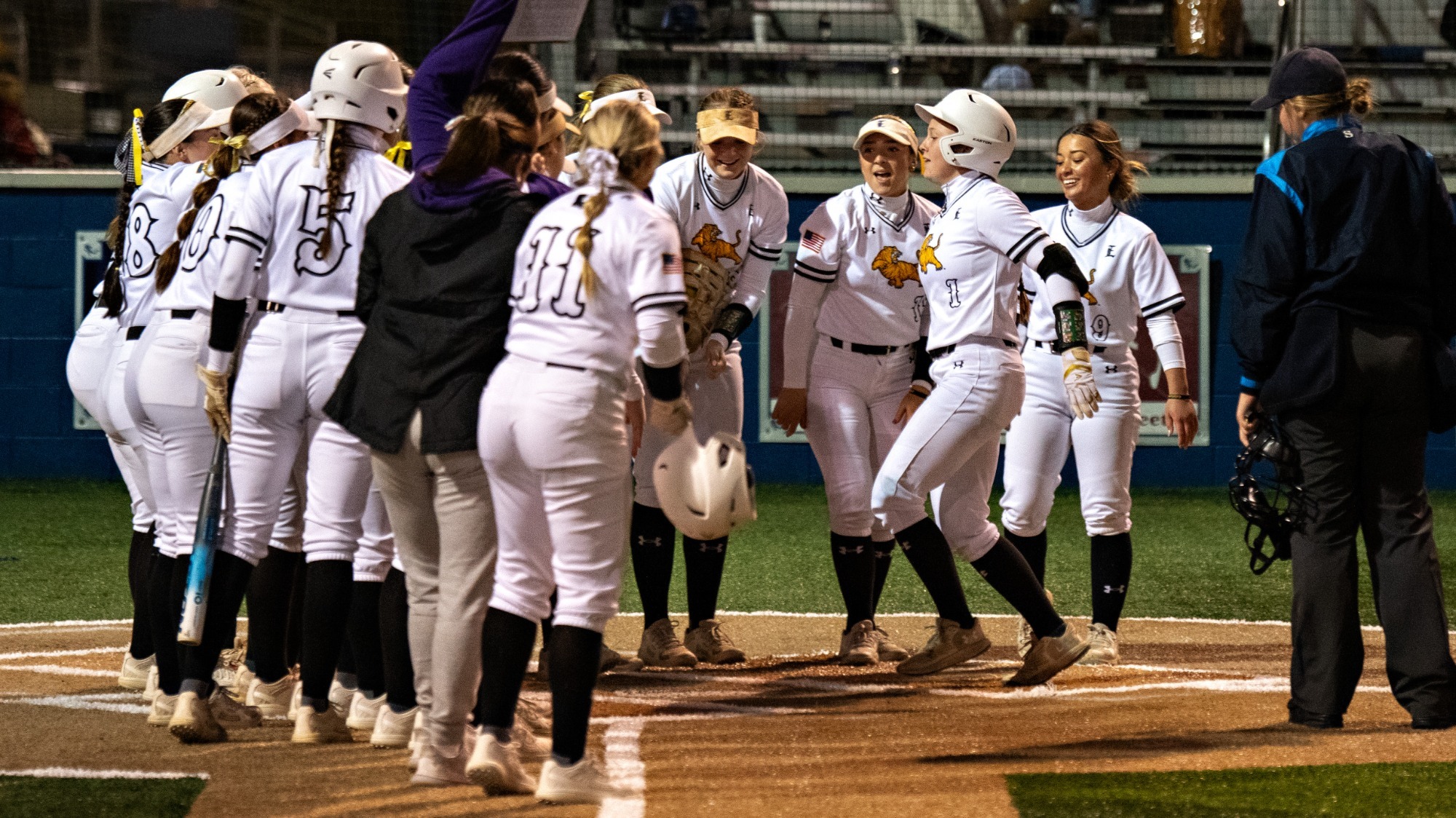 Payton Prince celebrates with her team following a home run.